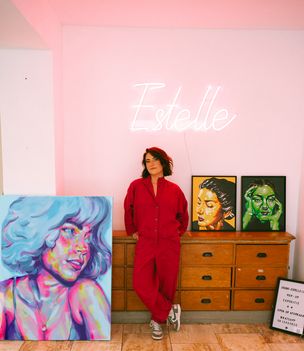 Artist Estelle from Studio Estelle stands next to paintings from her series Love in All Colours, Neon and Passion for her upcoming expo at Bunk Utrecht